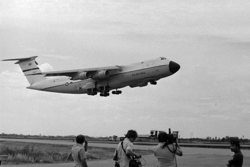 Lockheed C-5A Galaxy 68-0218 lifts off from Tan Son Nhut Air Base, South Vietnam, 4 April 1975. (CORBIS)