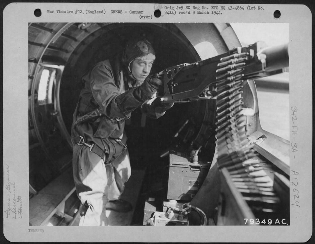 This photograph shows SSGT Smith with a Browning .50-caliber machine gun at the left waist position of a B-17 Flying Fortress. (U.S. Air Force) 