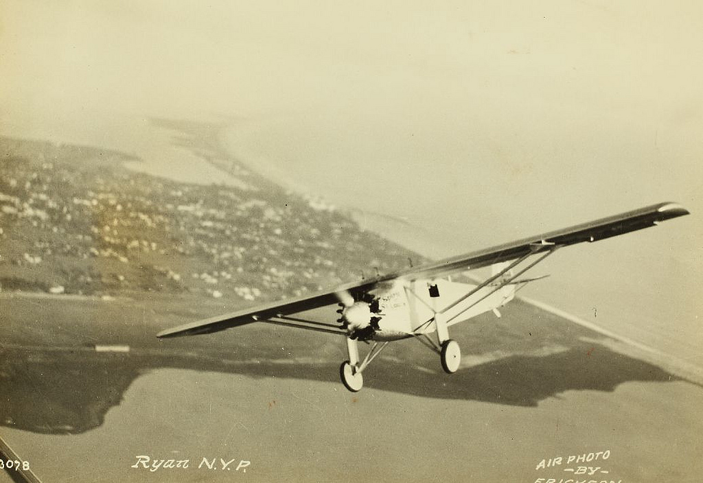 Charles A. Lindbergh and the Spirit of St. Louis over San Diego Bay. Photograph by H.A. Erickson. (San Diego Air and Space Museum)