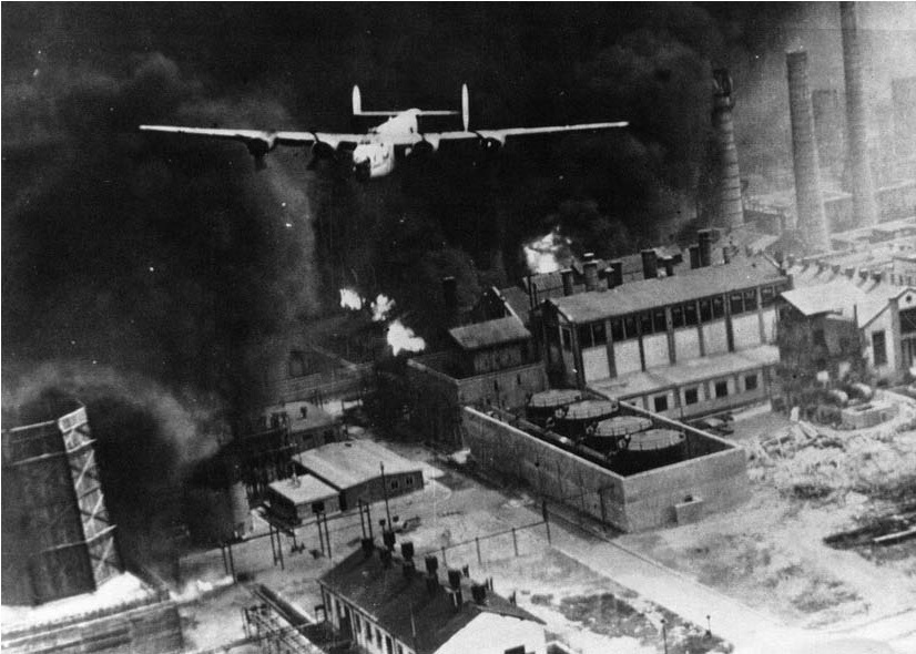 Consolidated B-24D-55-CO Liberator 42-40402, The Sandman, clears the triple stacks at Astra Romana, Ploesti, Romania, 1 August 1943. (U.S. Air Force)