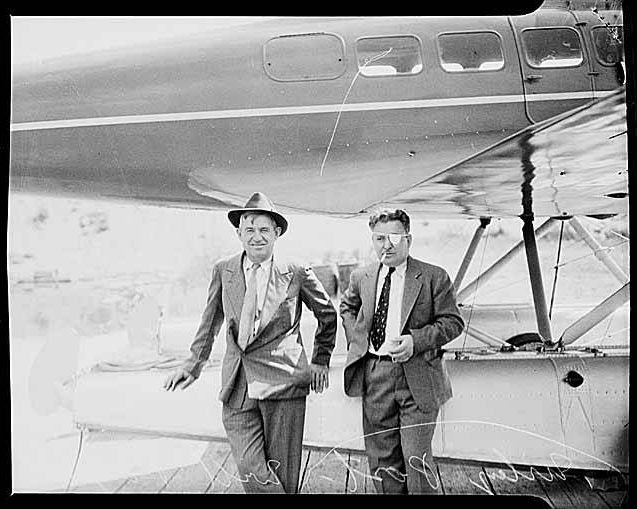 Will Rogers and Wiley Post with the Lockheed Model 9E Orion hybrid at Renton, Washington. The pontoons have just been installed on the airplane in place of its fixed landing gear. (Unattributed)