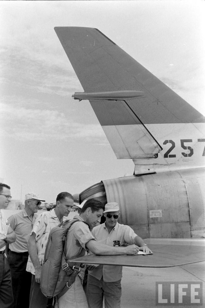 Scott Crossfield signs the maintenance forms for an F-100, certifying the airplane ready for flight. (LIFE Magazine via Jet Pilot Overseas) 