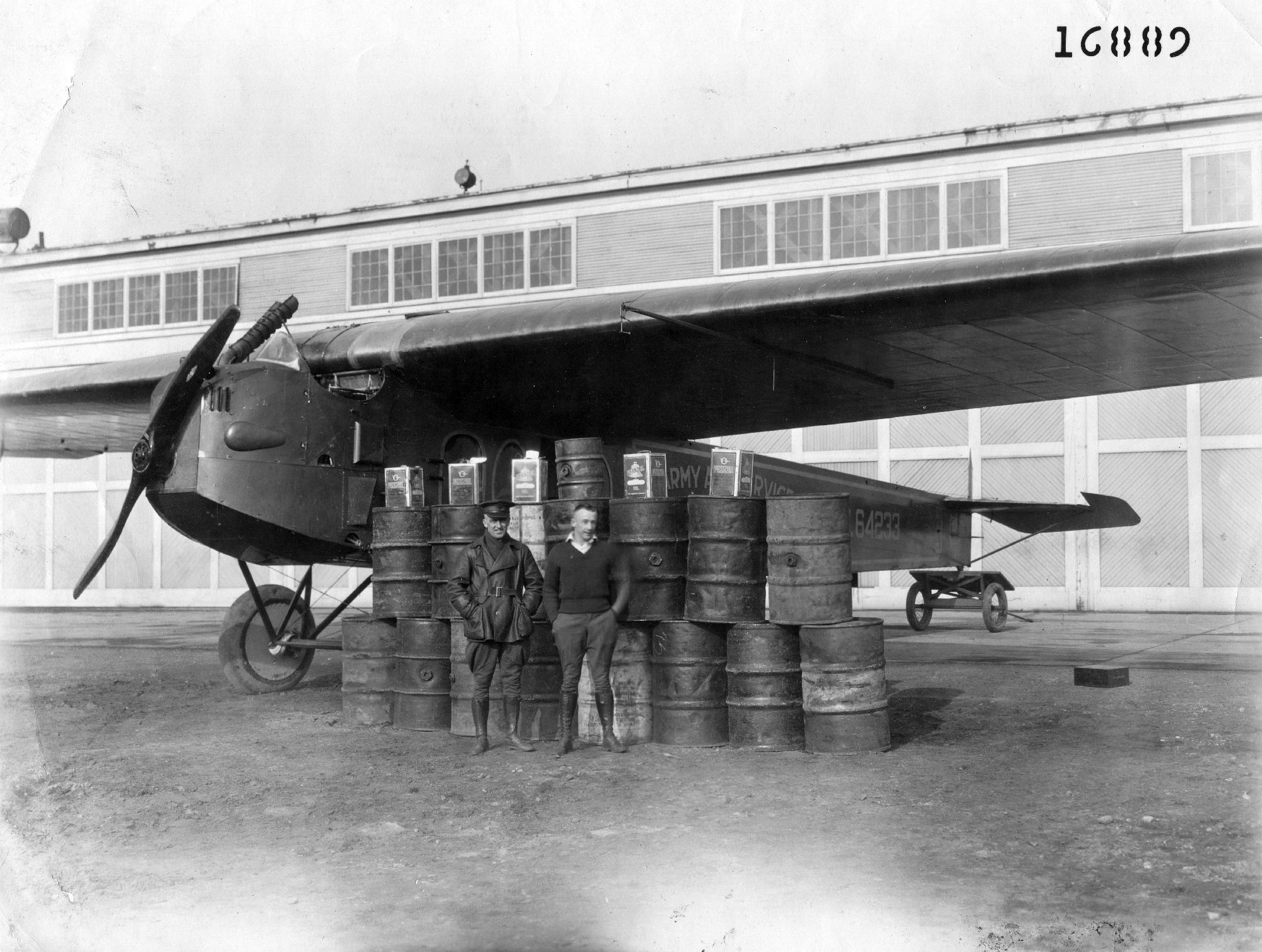 Lieutenants John Macready and Oakley Kelly with Fokker T-2, A.S. 64233. The fuel barrels and containers represent the fuel required for the airplane to cross the content non-stop. (San Diego Air and Space Museum)
