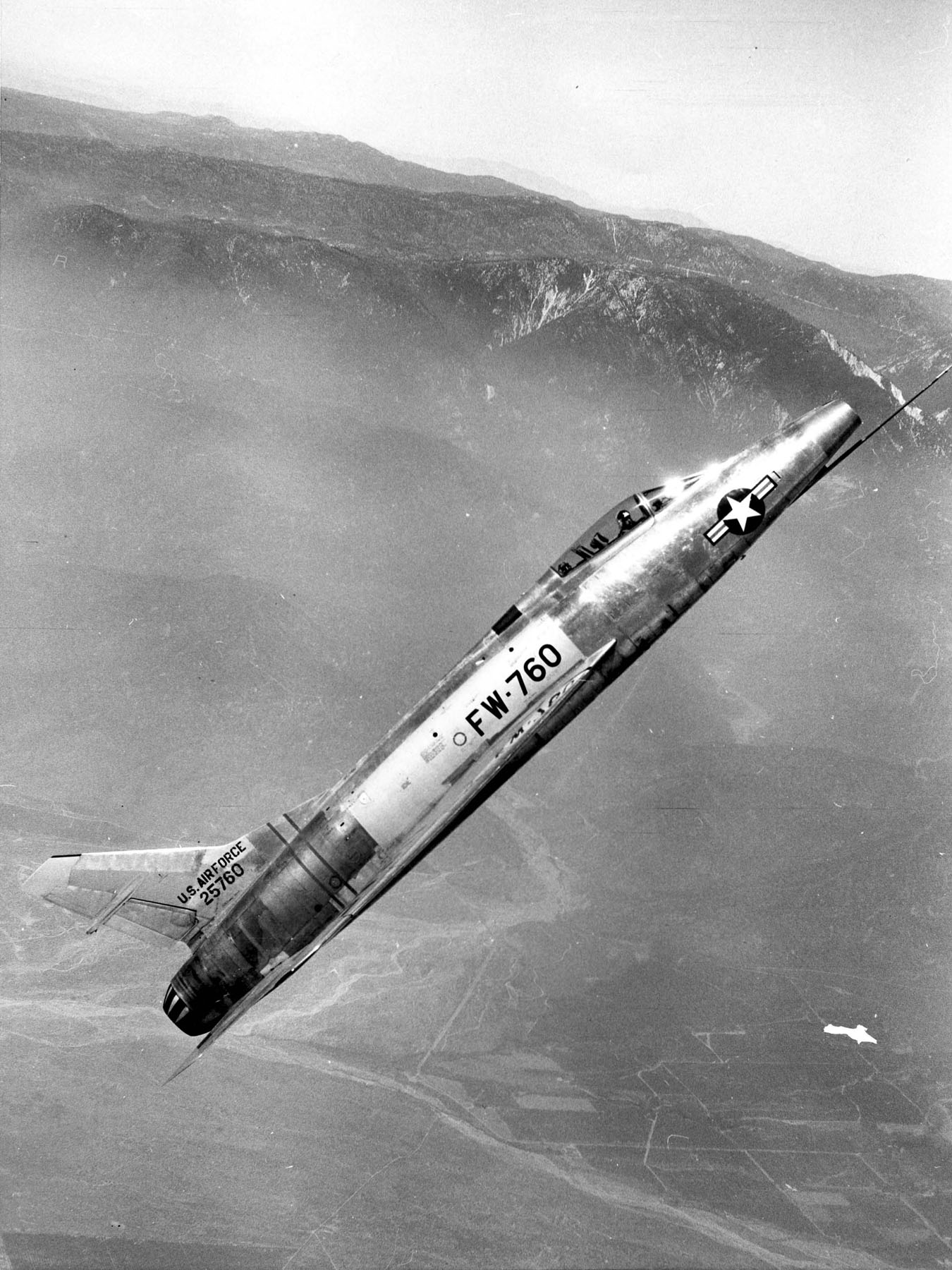 his is the fifth production F-100A-1-NA Super Sabre, 52-5760, in flight southeast of San Bernardino, California. This fighter is from the same production block as 52-5764, the fighter being tested by George Welch, 12 October 1954. In this photograph, FW-760 has the taller vertical fin that was designed to improve the Super Sabre's controlability. (U.S. Air Force)