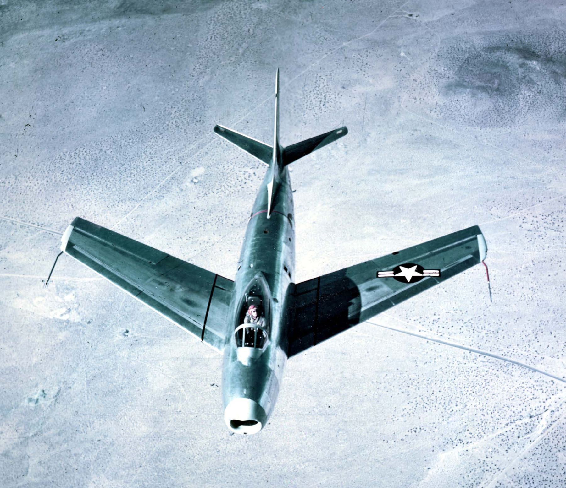 Test pilot George S. Welch, wearing his distinctive orange helmet, in the cockpit of the prototype XP-86. This photograph was taken 14 October 1947. (U.S. Air Force)