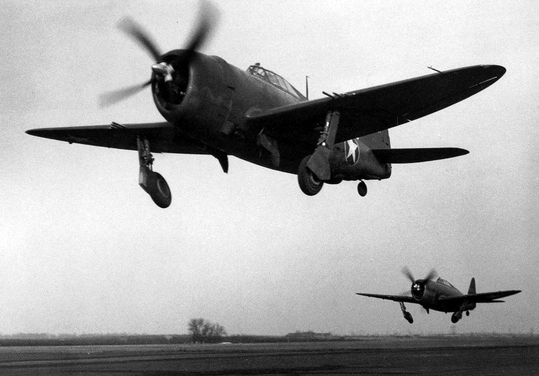 Two Republic Aviation Corporation P-47C Thunderbolts of the 56th Fighter Group retract their landing gear after takeoff. (U.S. Air Force)