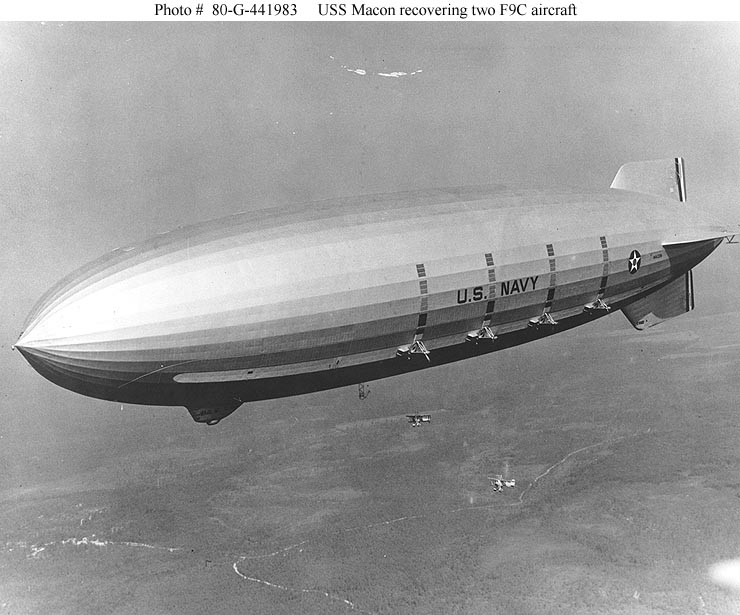 USS Macon (ZRS-5) recovering two Curtiss F9C Sparrowhawk scout biplanes. (U.S. Navy)