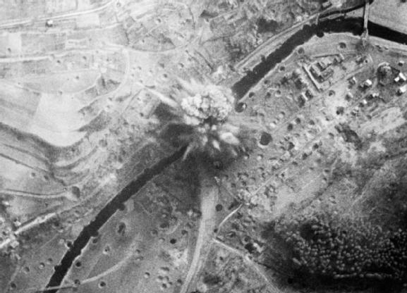 The Grand Slam bomb dropped by Flying Officer Martin's Avro Lancaster exploeds underneath the railway viaduct at Arnsberg, Germany. (Imperial War Museum)