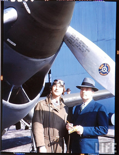 Chief test Pilot H. Lloyd Child (left, wearing goggles and flight suit) with a P-40 Warhawk. (LIFE Magazine)