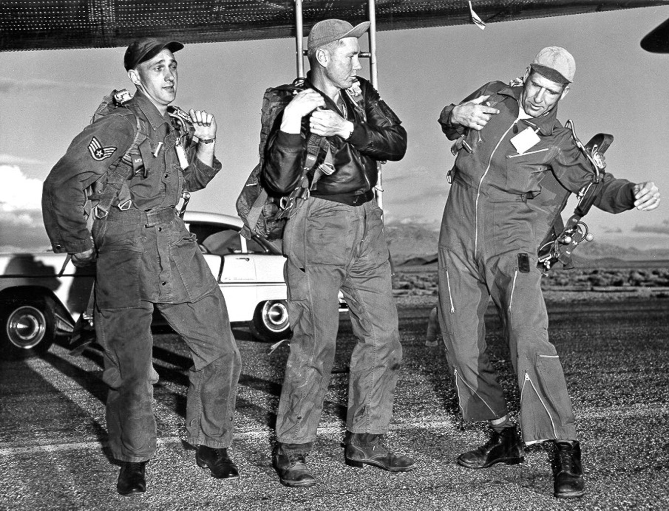 Three flight crewmen don their parachutes before boarding the B-36H Peacemaker for Operation Teapot HA, 5 April 1955. The automobile behind them is a 1955 Chevrolet Bel Air 4-door sedan. (U.S. Air Force)