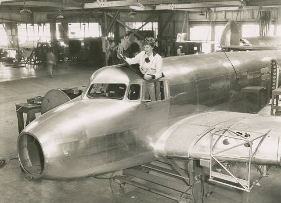 Amelia Earhart stands in the cockpit of her unfinished Lockheed Electra 10E Special, serial number 1055, at the Lockheed Aircraft Company factory, Burbank, California, 1936. (Purdue University Libraries, Archives and Special Collections)