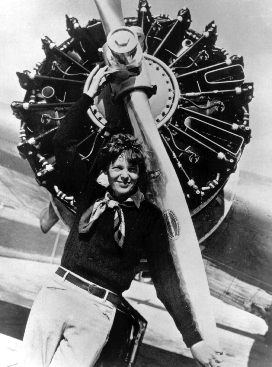 Amelia Earhart poses with her Electra's Pratt and Whitney R-1340-S3H1 Wasp radial engine and two-bladed Hamilton Standard variable-pitch, constant-speed propeller.
