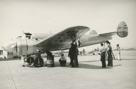 Lockheed technicians check the Electra's fuel capacity with the airplane in normal flight attitude. (Purdue)