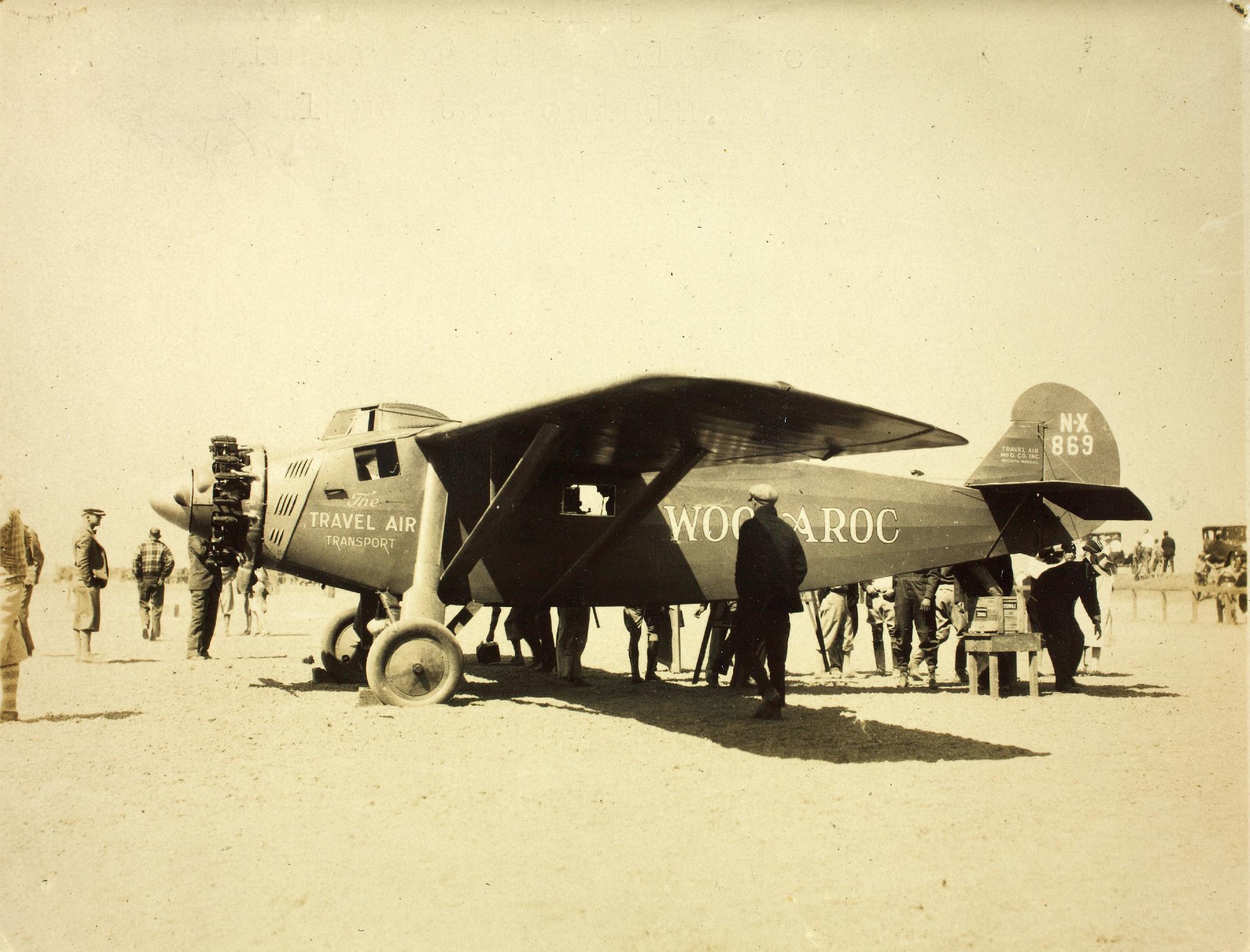 The Travel Air 5000 NX896, Woolaroc, being prepared for the Trans-Pacifc flight at Oakland, California, 16 August 1927. The airplane has been placed in flight attitude for calibration of its navigation instruments and to be certain the fuel tanks are filled to capacity. (San Diego Air and Space Museum Archives)