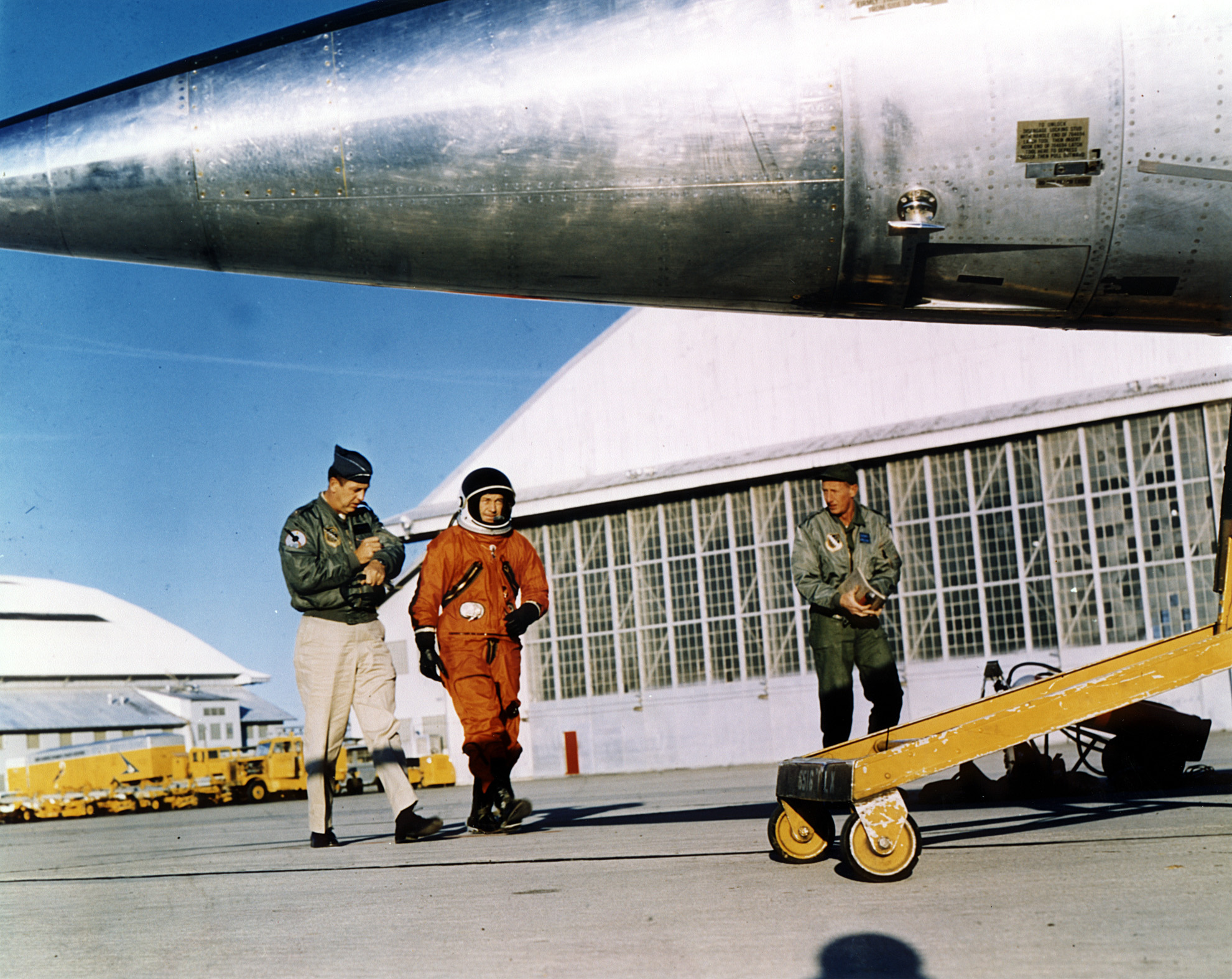 Colonel Charles E. Yeager, U.S. Air Force, wearing a David Clark Co. A/P22S-2 full-pressure suit, accompanied by Major Ralph N. Richardson of the Aviation Physiology Laboratory, Richardson, walks to a Lockheed NF-104A Aerospace Trainer at Edwards Air Force base. (U.S. Air Force)