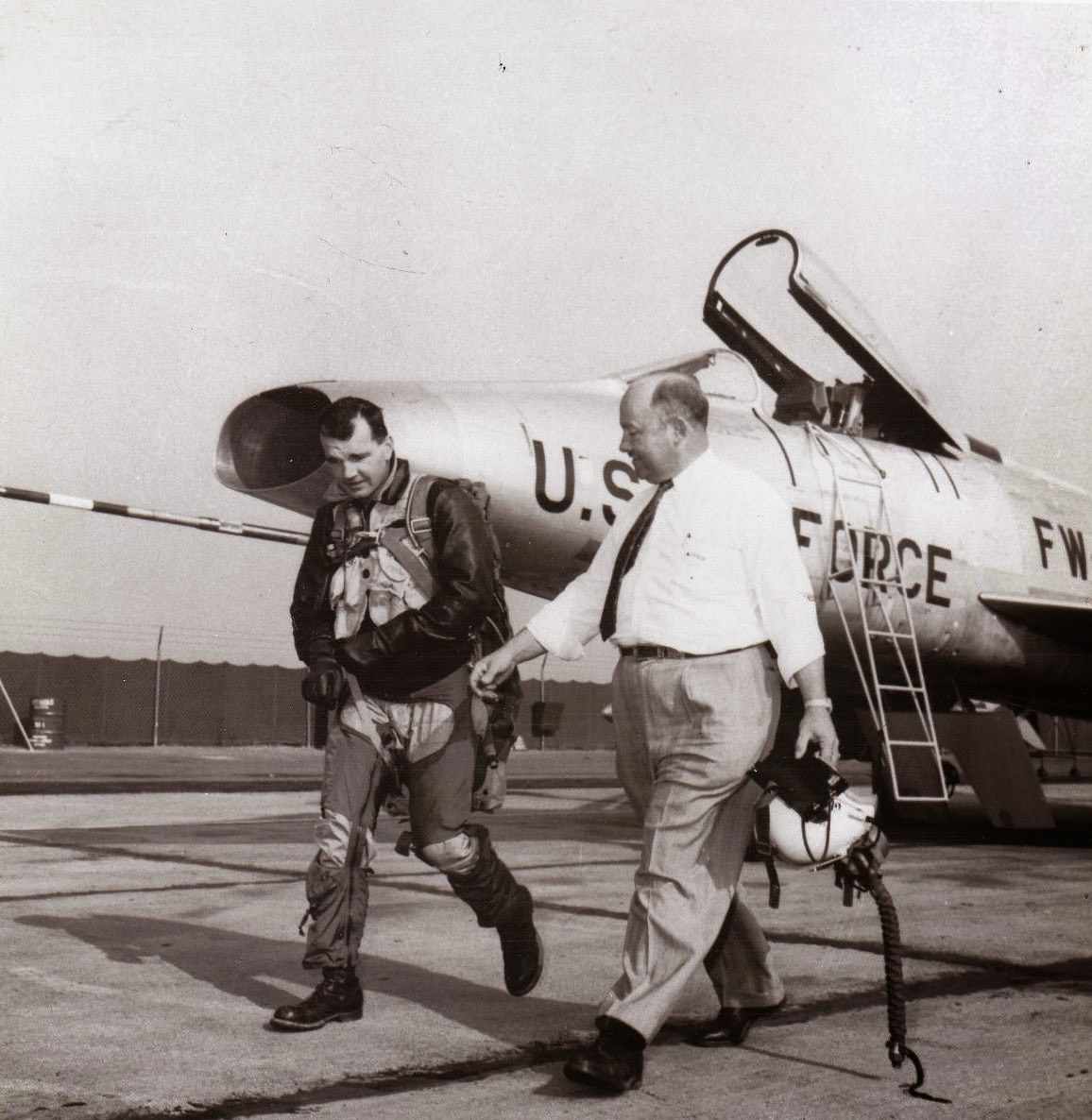 North American Aviation production test pilot George F. Smith (left) walks away from an F-100 Super Sabre. (Photograph courtesy of Neil Corbett, Test and Research Pilots, Flight Test Engineeers)