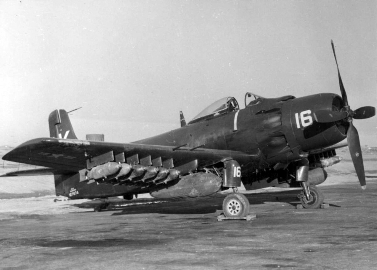 A U.S. Marine Corps Douglas AD-2 Skyraider of VMF-121 parked at airfield K-6, Pyongtaek, South Korea, 1952. The hard points under the wings are fully loaded with bombs.