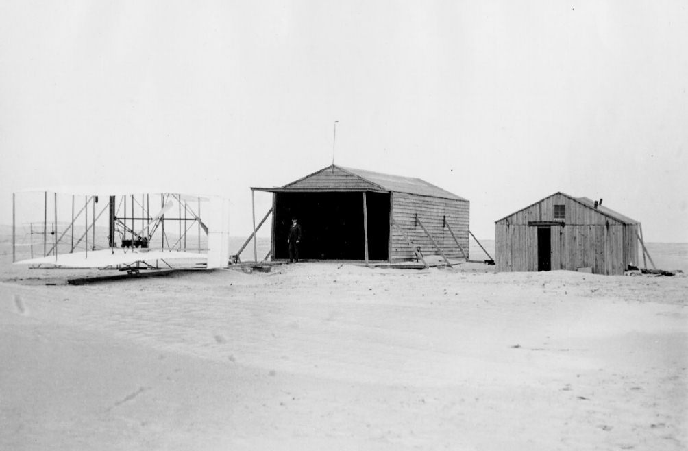The Wright's airfield at Kittyhawk, North Carolina. Wilbure Wright is standing in the hangar. (Wright Brothers Aeroplane Company)