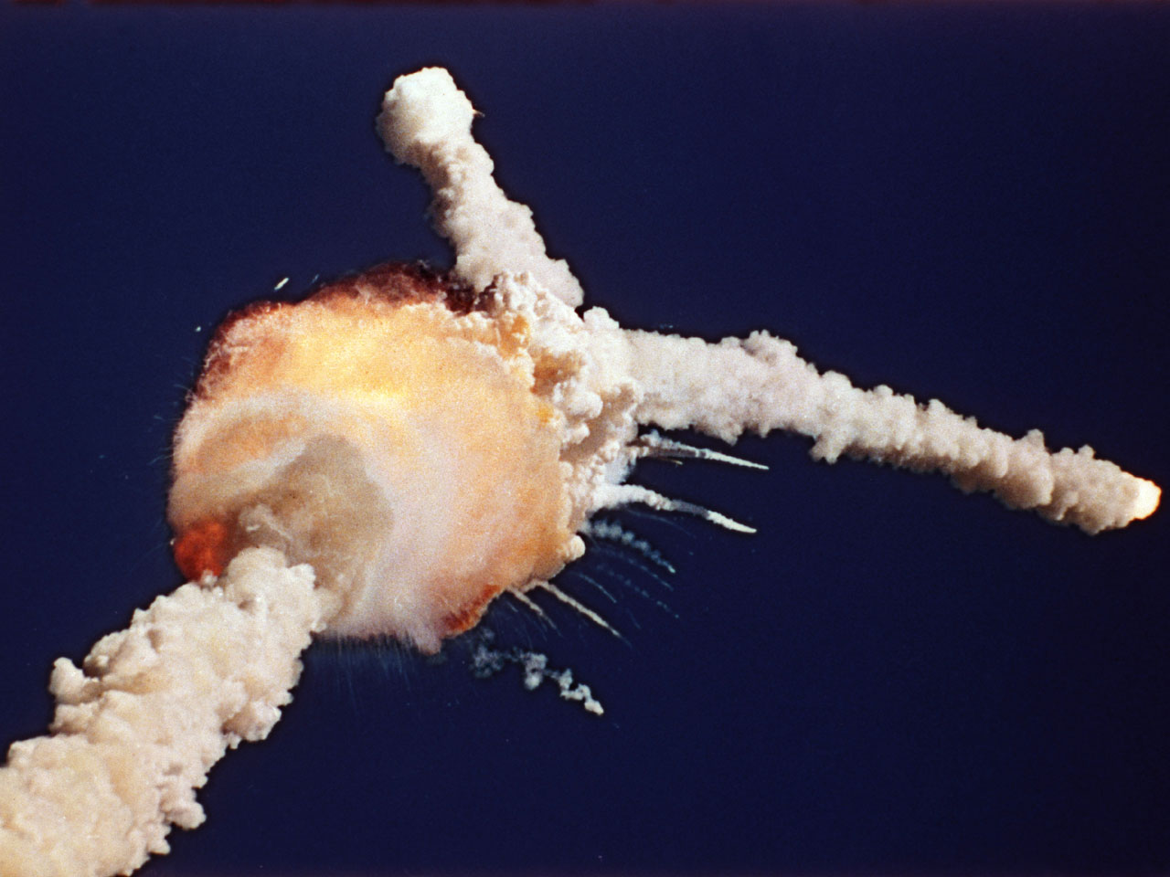 Challenger’s external tank, containing liquid hydrogen and liquid oxygen, exploded 1 minute 13 seconds after liftoff. The two solid rocket boosters flew off in different directions. (Bruce Weaver/AP)
