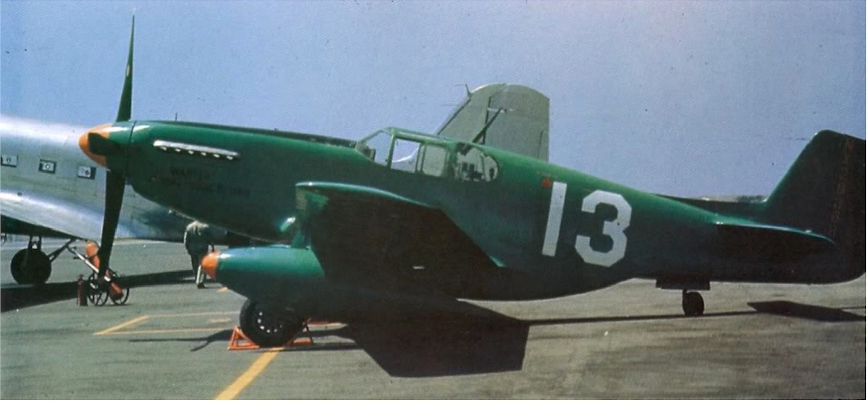 Jackie Cochran’s North American Aviation P-51B-15-NA Mustang NX28388, #13, with drop tanks, at Van Nuys Metropolitan Airport, California, August 1946. Left profile. Color. (Unattributed)