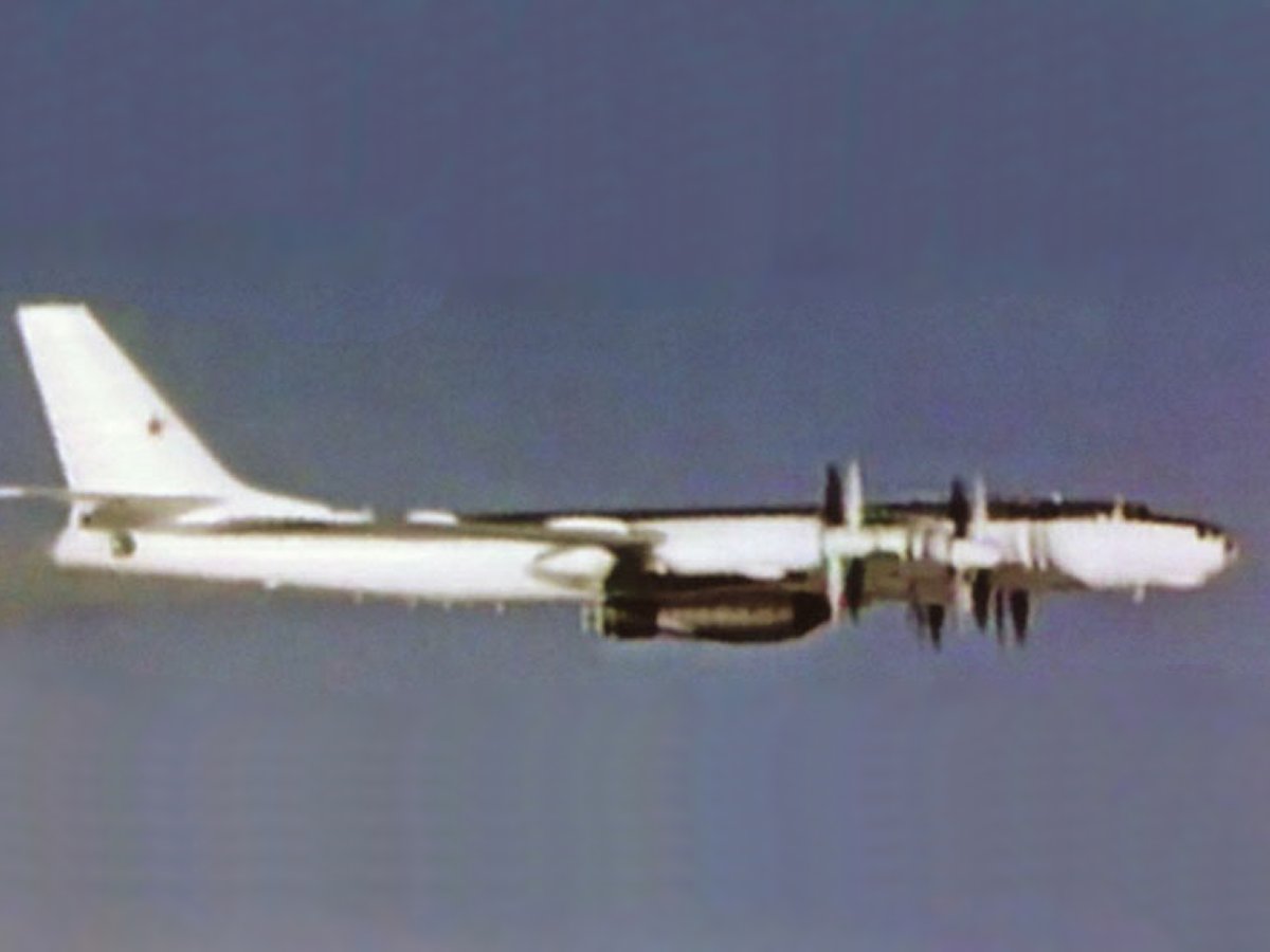 A left underside view of a Soviet Tu-95 Bear D aircraft in flight