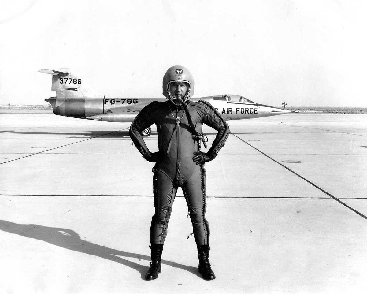 Lockheed's Chief Test Pilot, Anthony W. ("Tony") LeVier, is wearing a David Clark Co. T-1 capstan-type partial-pressure suit and K-1 helmet. The first prototype XF-104, 53-7786, is behind him. (U.S. Air Force)
