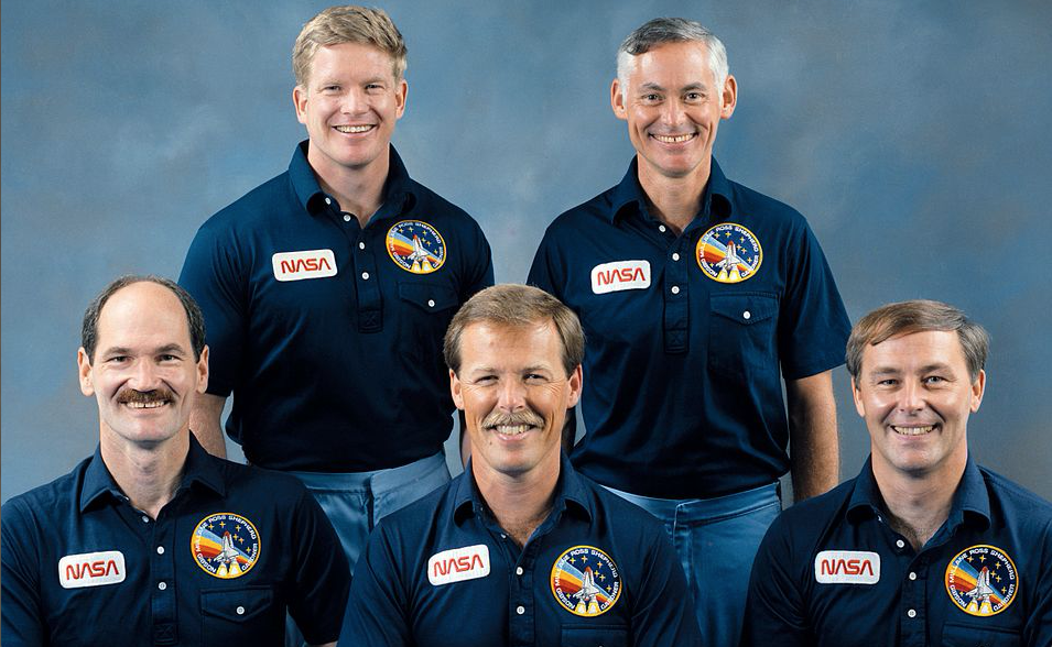 Seated, left to right, are Guy S. Gardner, pilot; Robert L. Gibson, commander and Jerry L. Ross, mission specialist. On the back row, left to right, are mission specialists William M. Shepherd and Richard M. Mullane.