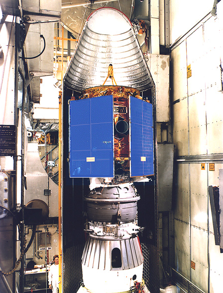 NEAR space probe inside a protective cover. A man at the lower left of the image provides scale. (NASA)