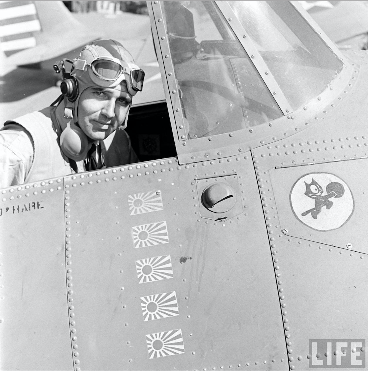 Lieutenant "Butch" O'Hare in teh cockpit of his Grumman F4F-3 Wildcat fighter. The "Felix the Cat" insignia represents the Fighter Squadron. The five flags signify the enemy airplanes destroyed in combat 20 February 1942. (LIFE Magazine)