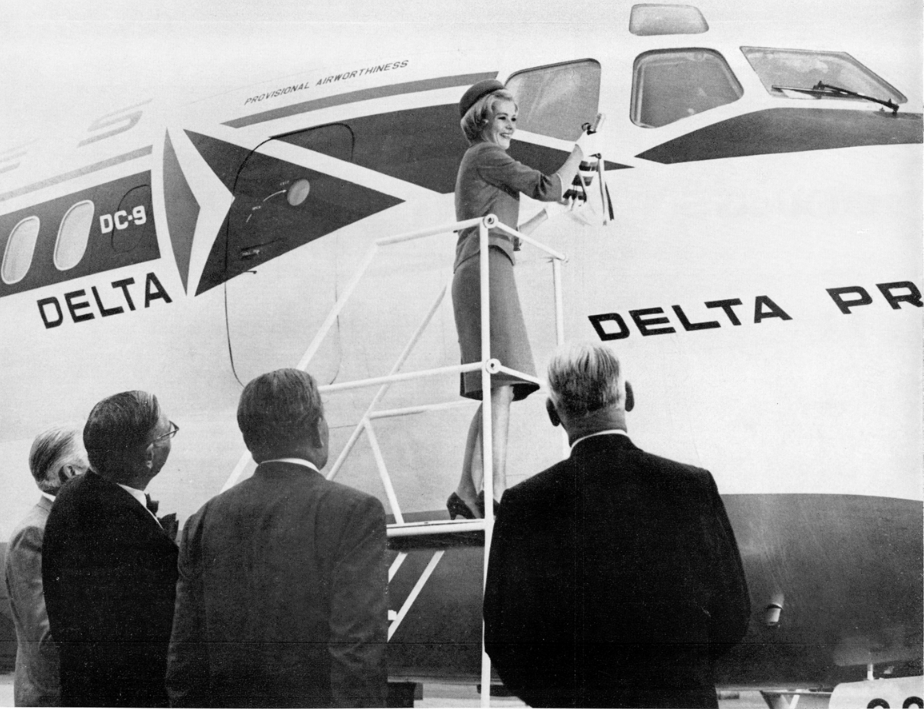 Miss Carol Koberlein christens Delta's first Douglas DC-9, N3304L, Delta Prince, with water from 20 rivers in the airline's area of operations. (Delta Digest)