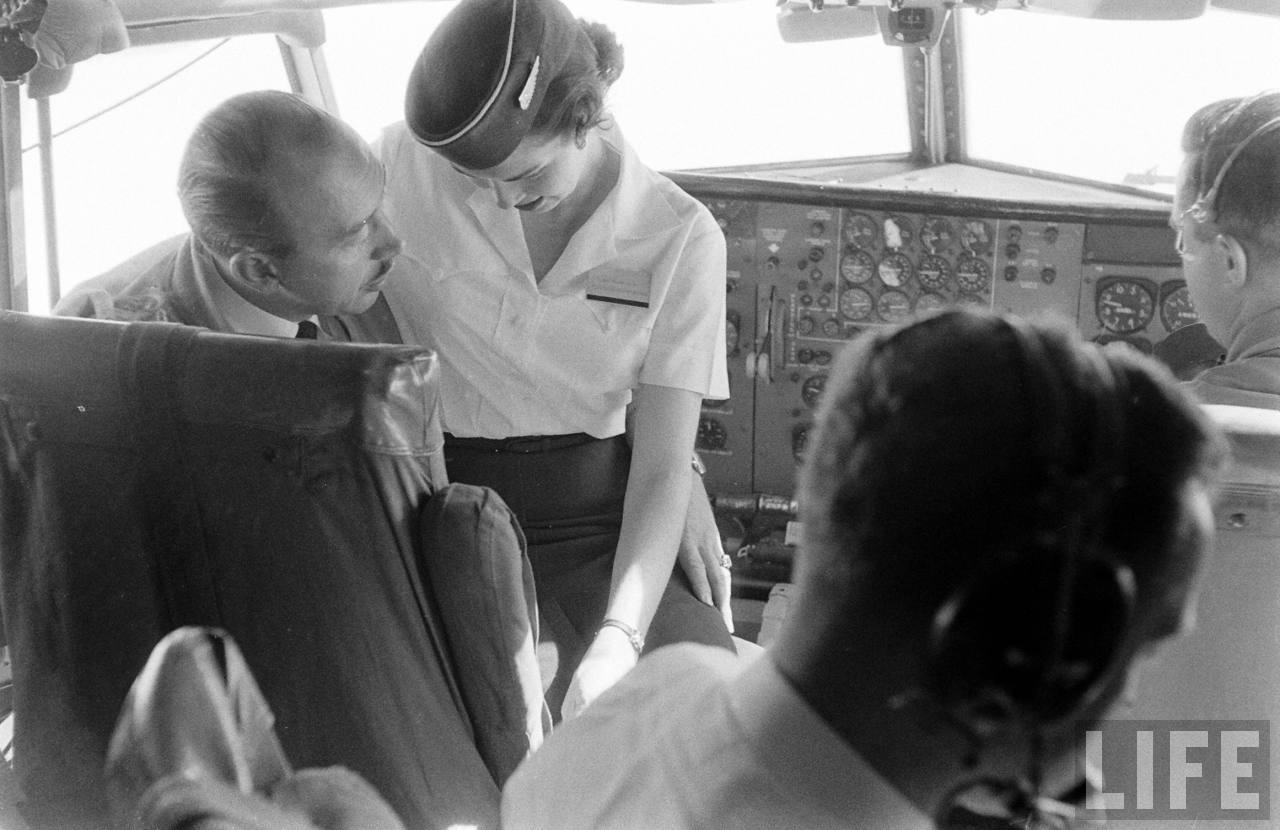 Boeing's Chief of Flight Test, Alvin M. "Tex" Johnston updates a memeber of teh cabin crew on the progress of the flight. (Leonard Mccombe/LIFE Magazine)
