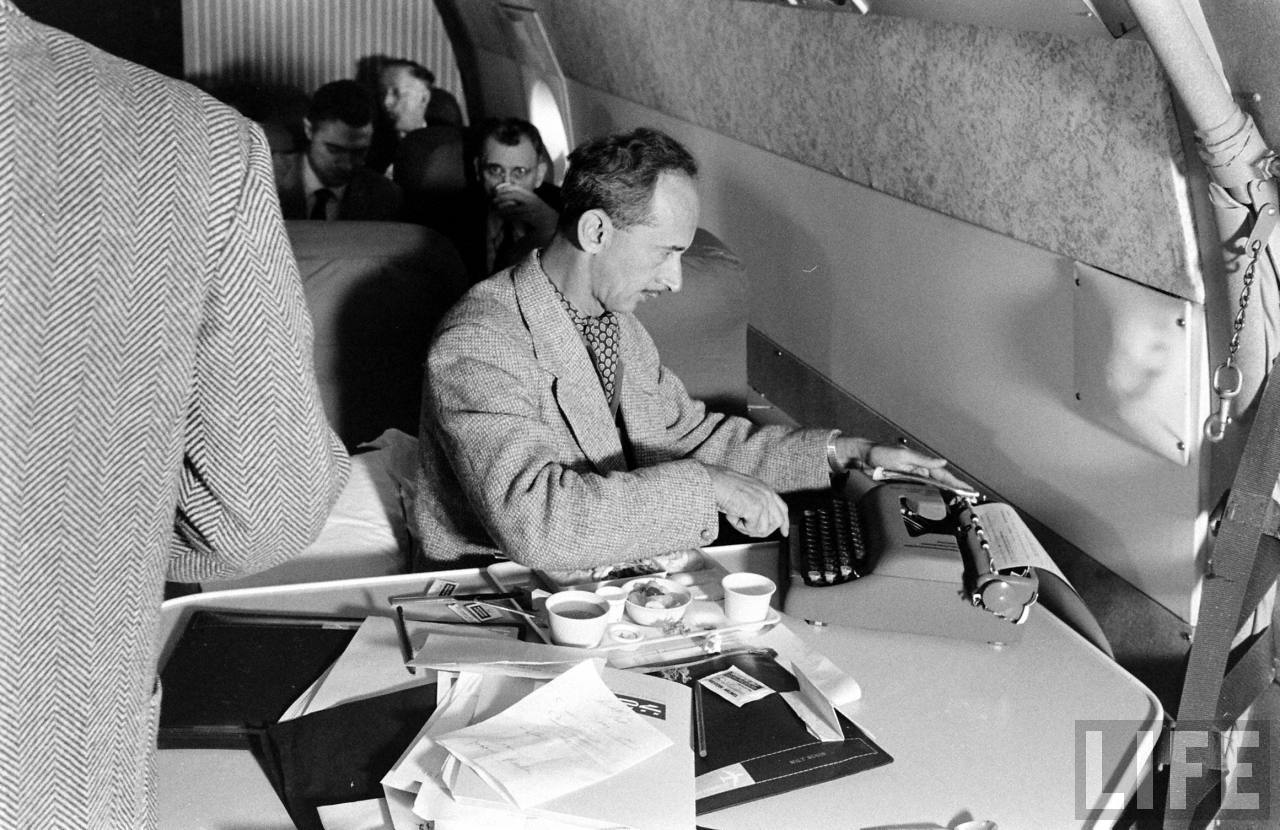 A news reporter types his story during the transcontinental flight. (Leonatd Mccombe/LIFE Magazine)