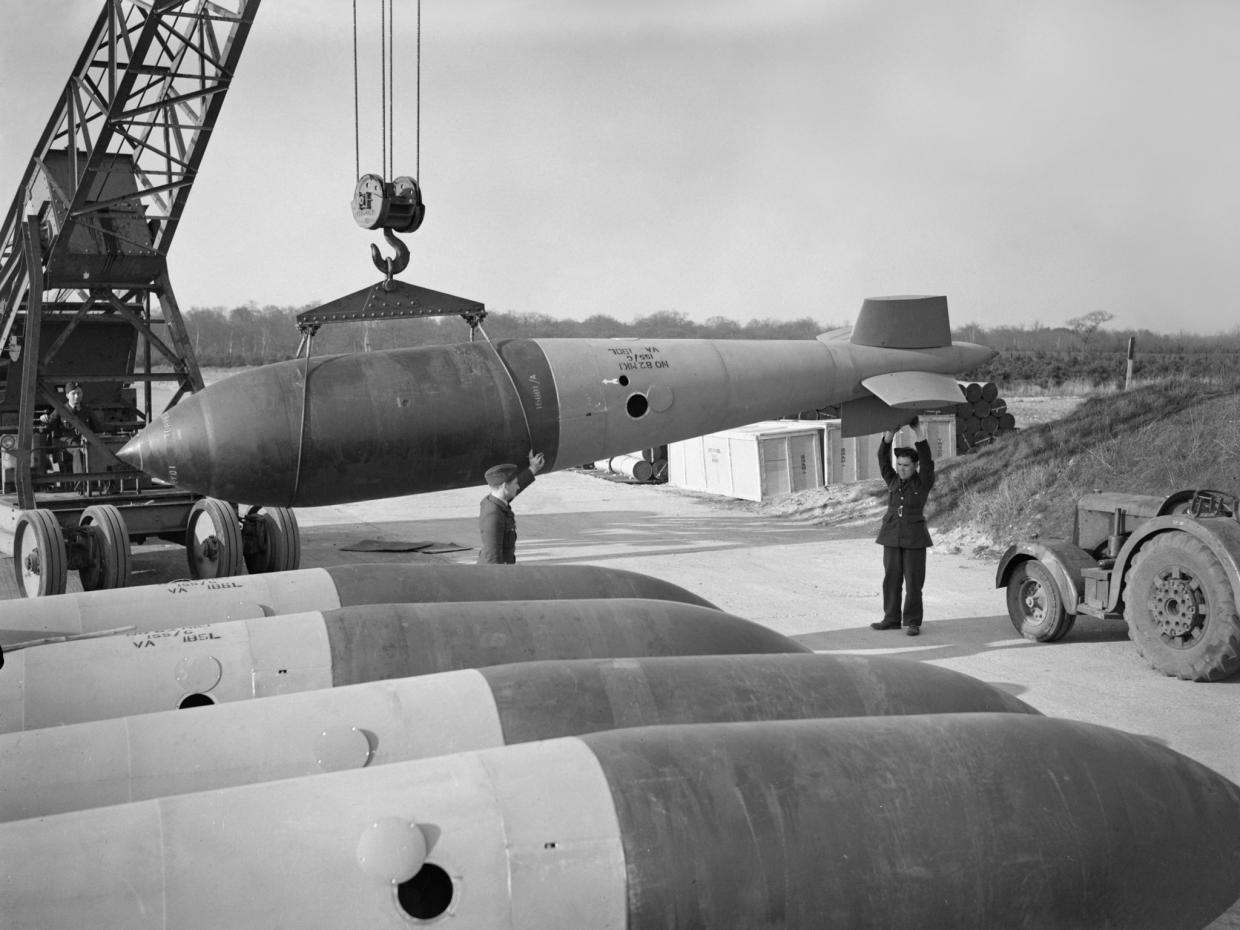 A "Bomb, Medium Capacity, 22,000 Pounds, lifted by a crane at a Royal Air Force bomb dump. (Imperial War Museum)