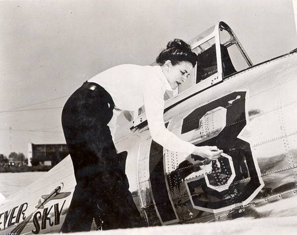 Jackie Cochran paints her race number, 13, of the fuselage of her Seversky AP-7. (Unattributed)