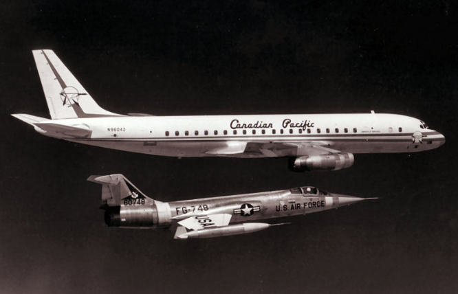 Douglas DC-8-43 N9604Z is accopmanied by a U.S. Air Force Lockheed F-104A Starfighter, near Edwards Air Force base, California.