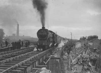 A LNER Class B-12/3 4-6-0 locomotive, 7488, pulls a passenger train across the rebuilt Grove Street bridge, 9:27 p.m., 14 June 1944. (Great Eastern Railway Society)