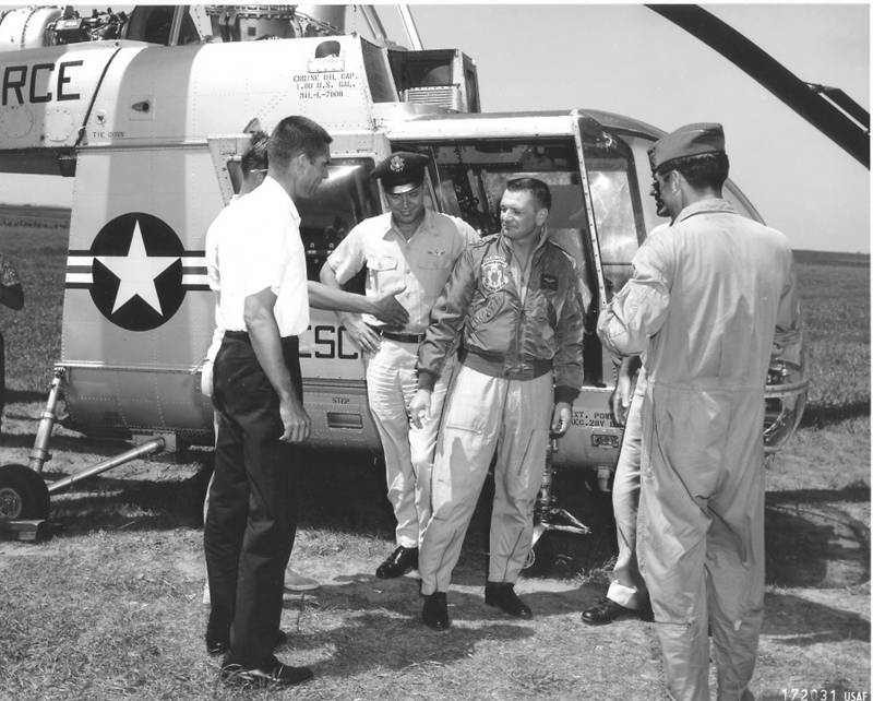 Captain Chet Radcliffe is congratulated on completion of the flight. The man in teh white shirt is Kaman Aircraft Company chief test pilot Andy Foster. (U.S. Air Force)