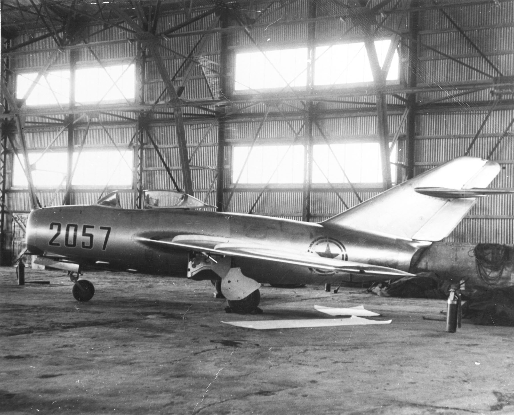 MIG 15 Red 2057A Chinese Mikoyan-Gurevich MiG 15bis in a hangar at Kimpo Air Base, South Korea. A defecting North Korean pilot, Lieutenant No Kum-Sok flew it to Kimpo 1953. It was examined and test flown. This MiG 15 is in the collection of the National Museum of the United States Air Force, Wright-Patterson AFB, Ohio. (U.S. Air Force).