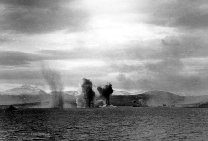 KMS Tirpitz under attack, 12 November 1944. The battleship is visible to the left of the bomb splashes and is firing its main guns at the bombers. (Unattributed)