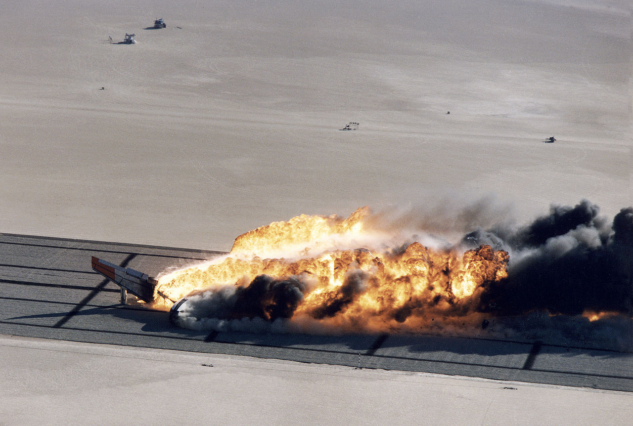 The flaming wreckage of NASA 833 slides to a stop on Rogers Dry Lake. Fire fighters needed more than one hour to extinguish the fire. (NASA)