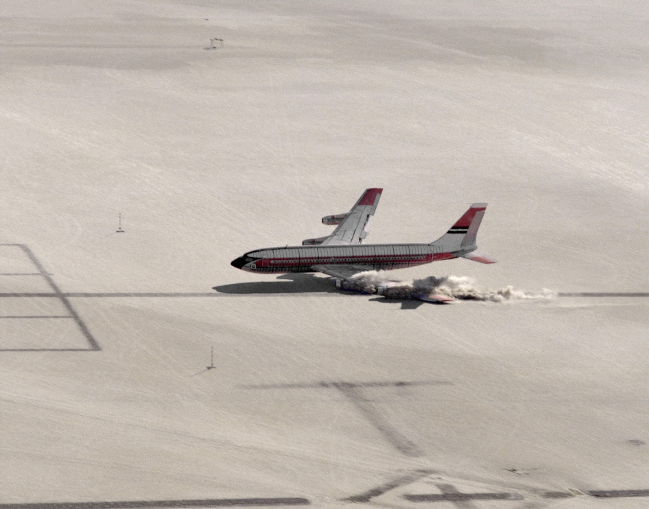 Just before touchdown, the Boeing 720 entered a "Dutch roll." The airliner's nose yawed to the left and the left wing dipped, striking the ground sooner than was planned. All four engines are still at full throttle. NASA 833 is to the right of the runway center line. (NASA)